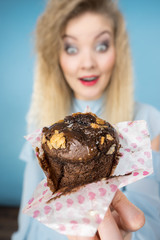 Attractive woman holds cake in hand