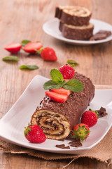 Chocolate roll with hazelnuts and strawberries. 