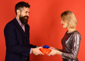 Girl and bearded man with cheerful faces and gift box