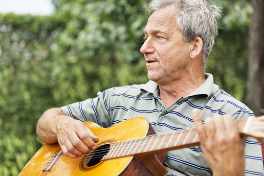 Mature Man Playing Acoustic Guitar