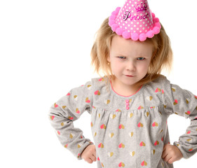 Young girl kid frowns in birthday party pink cap