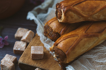 three tender cake with a spoon on a gray wooden background. Selective focus, close up