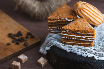 three tender cake with coffee beans on a gray wooden background. Selective focus, close up....