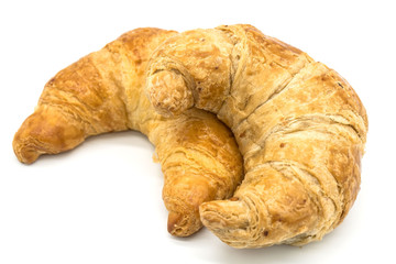Fresh two croissant isolated on a white background closeup .