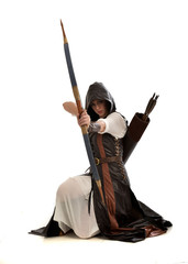 full length portrait of girl wearing brown  fantasy costume, holding a bow and arrow, on white...