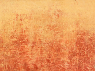 Old orange wall with red spots from below
