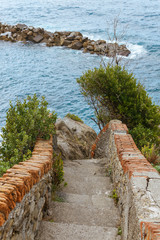 Fototapeta premium old stairs and beautiful seascape with stones in Riomaggiore, Italy