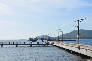 Jetty or walkway cement bridge to boats on the sea