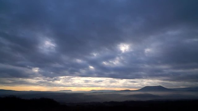 time lapse clouds in the evening sky in the mountains