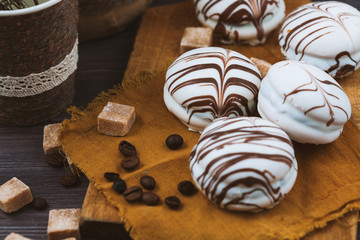 tender cake with coffee beans and with slices of sugar on a gray wooden background. Selective focus, close up. background for postcard.