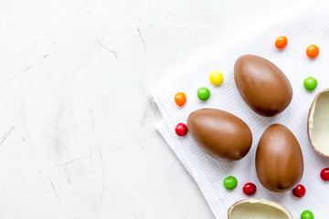 Easter chocolate eggs top view on stone background mock up