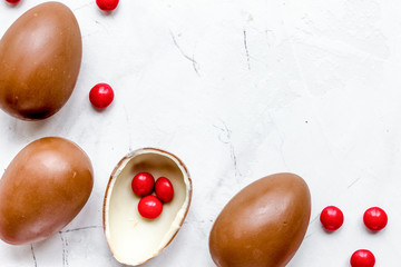 Easter chocolate eggs top view on stone background mock up