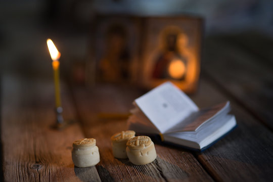 andle against the background of orthodox icons