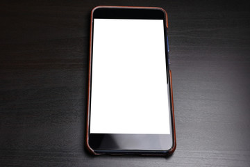 Black smart phone with white screen on dark background.