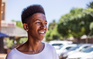 Young African Male on the streets of Johannesburg, South Africa, with cool street clothing and table top afro hairstyle.