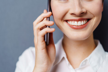 Smiling woman chatting on a mobile phone