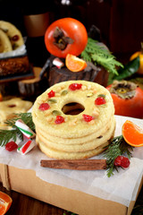 Shortbread cookies shaped as rings decorated with dried cherry and nuts. Christmas festive treat