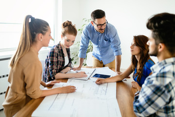 Image of business partners discussing documents and ideas