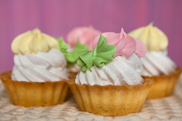 Obraz na płótnie Canvas Colorful cupcakes on pink background, sweet food