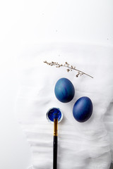 Eggs painted blue color on Easter holiday. White background, copy space