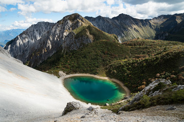 An unnamed alpine lake sits high in the Tianbaoshan Mountains, south of Shangrila in Yunnan Province, China