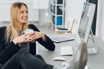 Attractive businesswoman reading her monitor