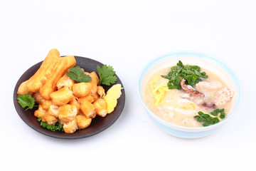 Rice porridge with  boiled egg ,Minced pork ,chicken liver, Ginger, onion and coriander served with Patongko ,deep-fried dough stick.