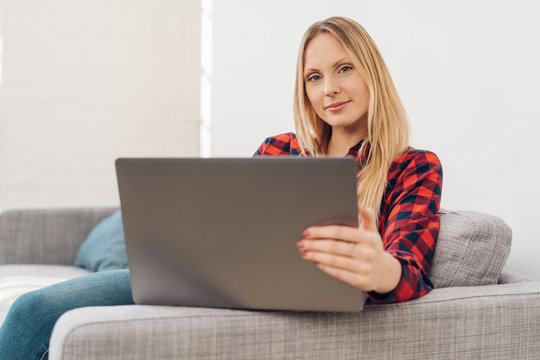 Woman relaxing with her laptop at home