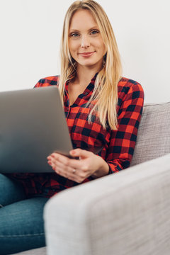 Relaxed friendly woman using a laptop at home