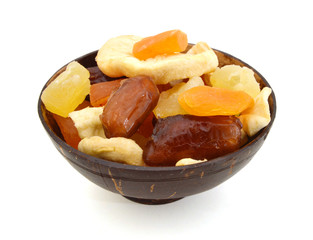 Bunch of tutti frutti in wooden bowl on a white background