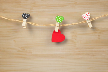 Handmade wood hearts hanging on cloth line or rope with