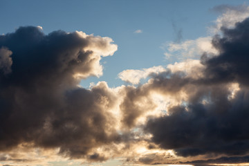 Fototapeta na wymiar Big dark clouds on blue sky at evening