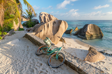 Bike parked on a beautiful tropical beach. Holiday concept - obrazy, fototapety, plakaty