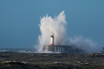 Fototapeta na wymiar Waves over Lighthouse