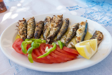 Seafood, grilled sardines served in traditional Greek tavern. Naxos island. Greece.