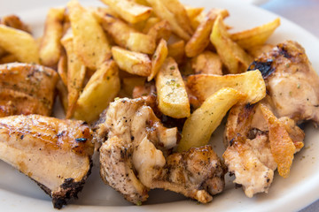 Traditional Greek chicken souvlaki served with fries in tavern on Naxos island. Cyclades. Greece.