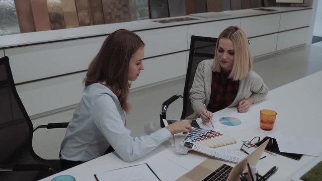 Young Designers Working On Color Ideas Discussing Pie Chart