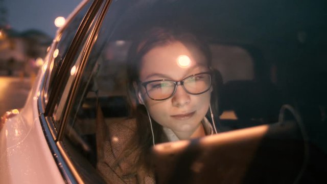 Young Woman Having a Nice Skype Call in the Moving Car