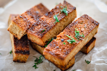 appetizing toasted toasts from rye bread with dill on white background.