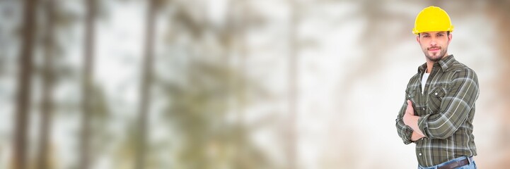 Construction Worker on building site by forest