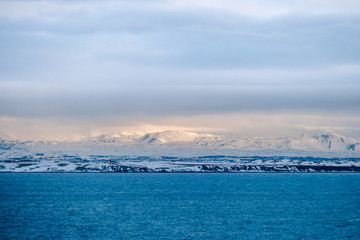 Beautiful view and winter Landscape picture of Iceland winter season with snow-capped mountain in the background and sea in the foreground
