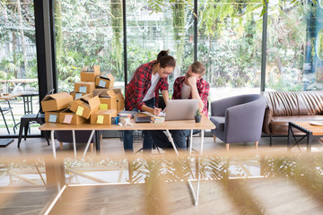 startup small business owner working at workplace. freelance man & woman seller check product order for delivery.  Online selling, e-commerce, shipping concept