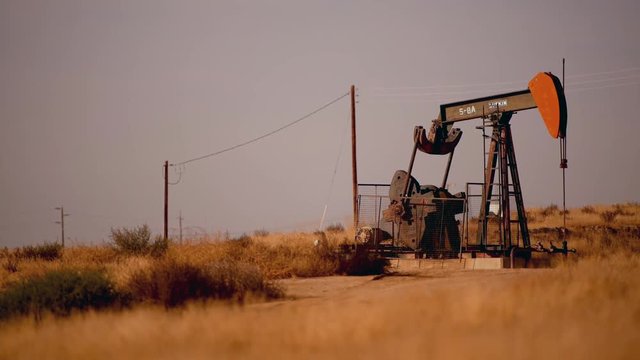 November 23, 2017. Southern California, United States. Working Lufkin Pumpjack Oil Pump on the Grassy Prairie