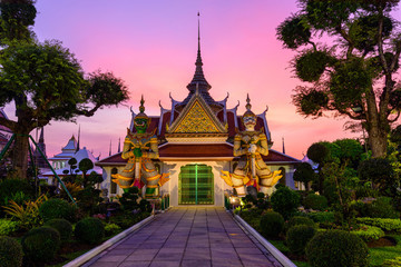 Bangkok , Thailand - 15 January, 2018: giant statue at white pagoda in Wat Arun Ratchawararam Ratchawaramahawihan in sunset time