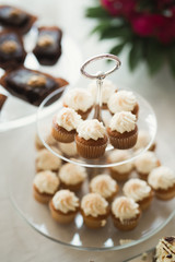 Delicious sweets on wedding candy buffet with desserts, cupcakes