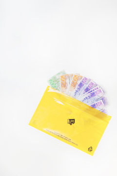 Yellow envelope with banknotes sticking out