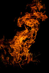 Obraz na płótnie Canvas Vertical photo of the bonfire flame on dark background