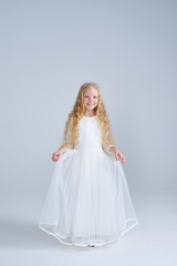 Fototapeta na wymiar Beautiful girl in white dress and diadem posing isolated