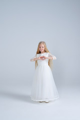 Fototapeta na wymiar Lovely princess making heart shape with her hands