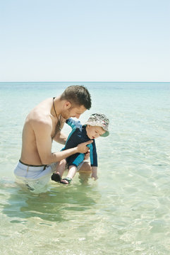 Father and son in sea
